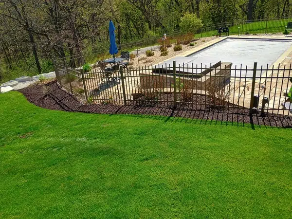 Mulch installation around pool beds in Brookfield, WI by Best Bark Mulch